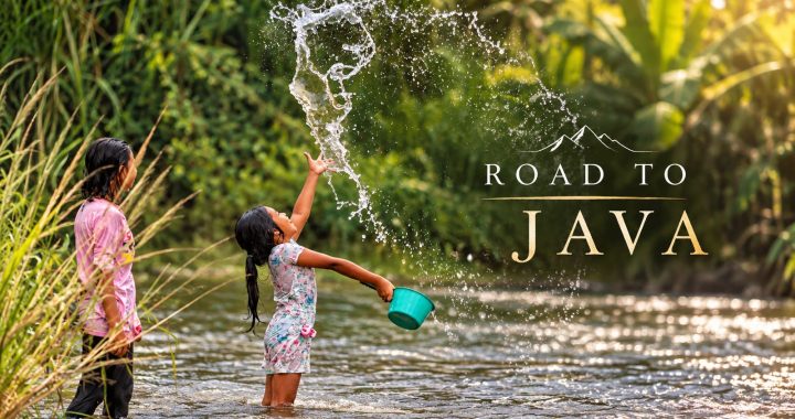 Two children play in a tropical river in Java, Indonesia, as one girl throws water into the air, capturing a joyful moment of everyday life in the Road to Java documentary.