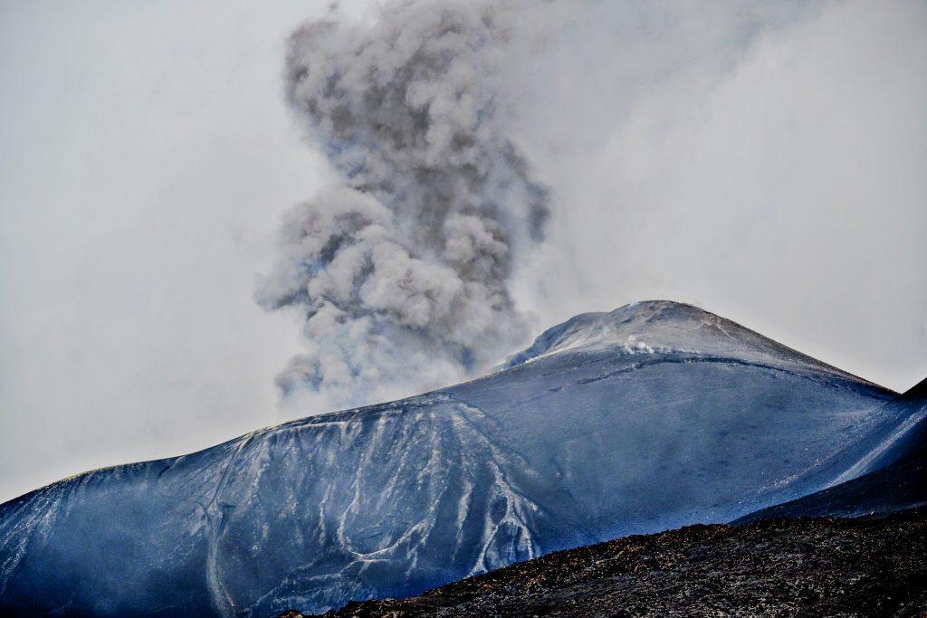 Eruption of Etna with release of ash above the crater.
