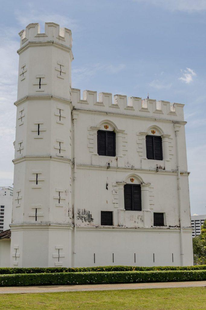 Main tower of Fort Margherita in Kuching, showing the black-shuttered windows and original colonial white walls.