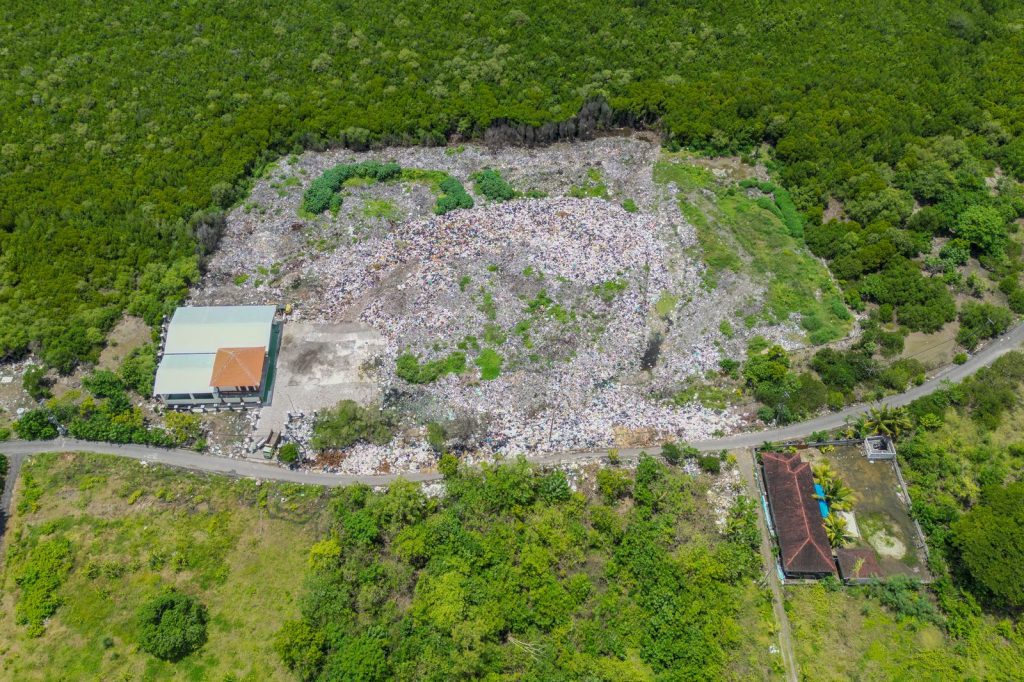 Aerial view of a plastic waste storage area located near a mangrove.