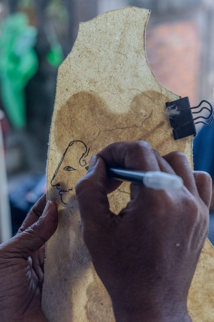 Drawing of the face of a Wayang Kulit puppet on buffalo leather in Bali.