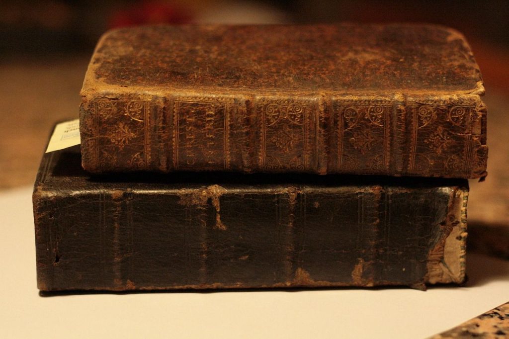 Two antique leather-bound books showing the marks and natural wear of the material.