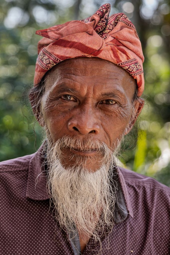 Portrait of a Balian wearing a red fabric headpiece "Udeng".