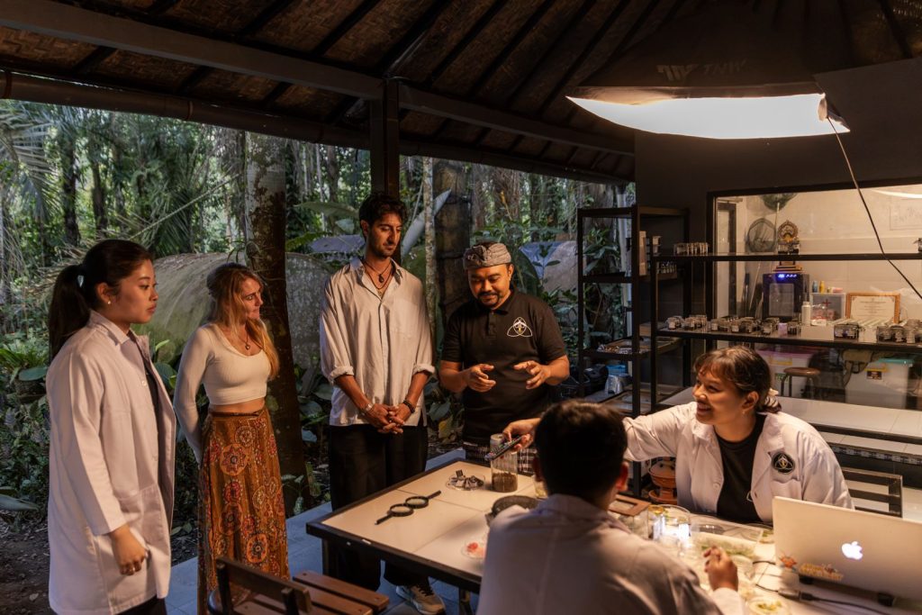 Wayan Wardika with researchers and visitors during a firefly conservation and research session in Bali.