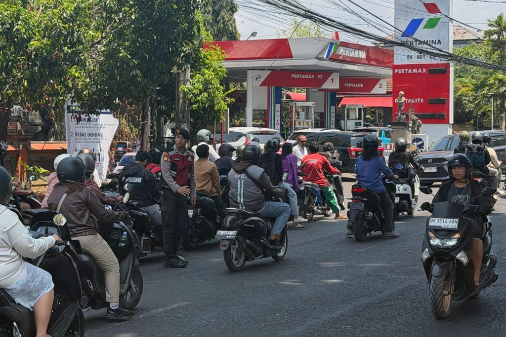 Motorcyclists queue outside a Pertamina petrol station during the Bali fuel shortage in October 2026.