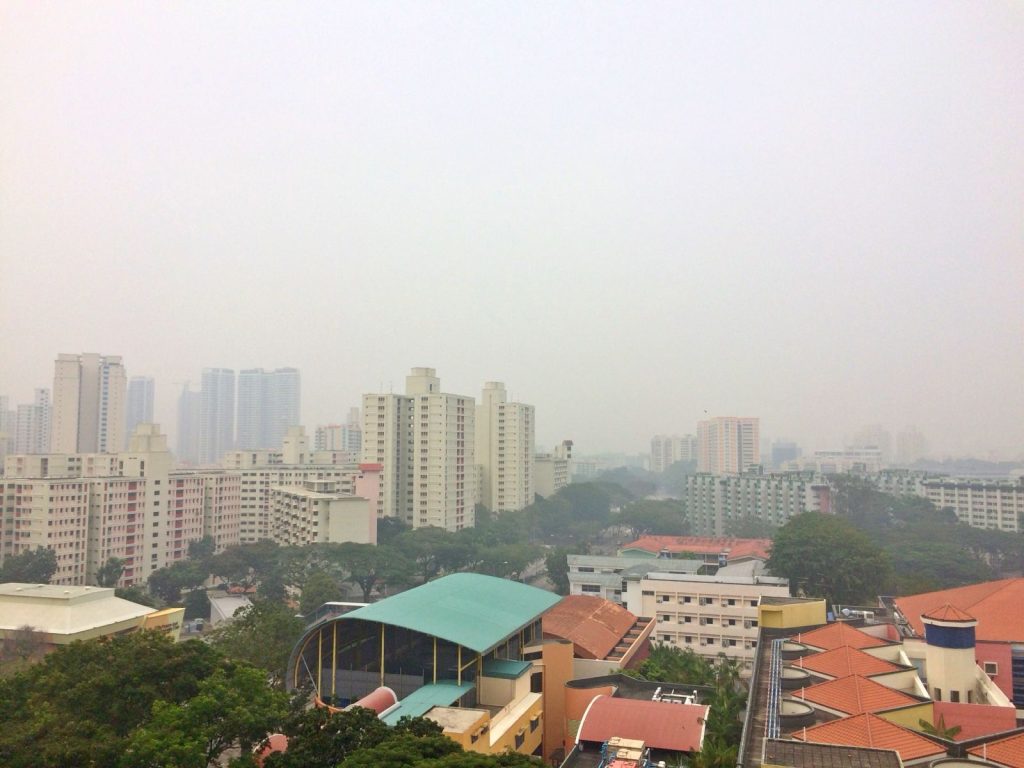 Thick haze covering Singapore's skyline, illustrating the regional impact of Indonesia wildfire haze on air quality.