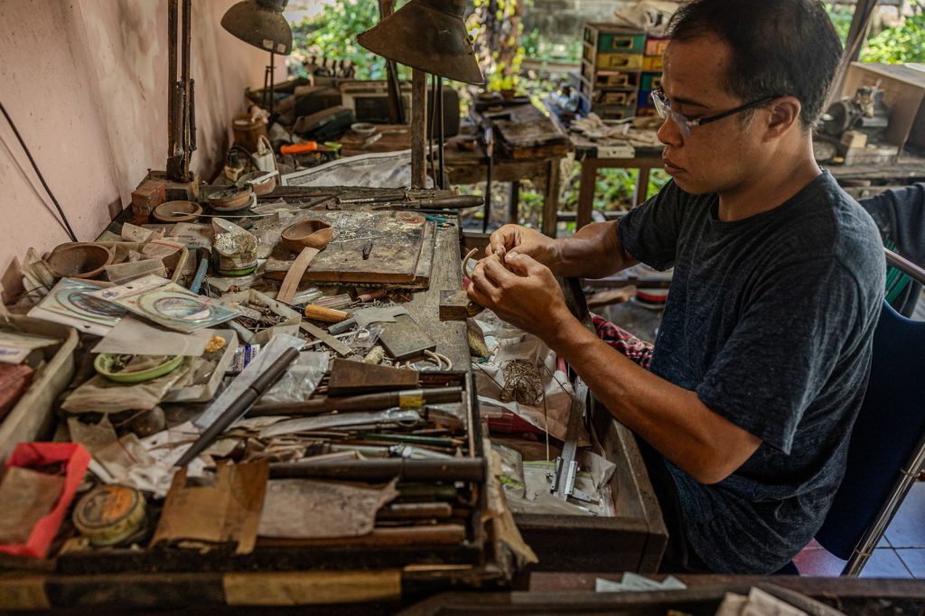 A craftsman working by hand in his workshop, preserving traditional skills and cultural knowledge.