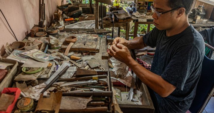 A craftsman working by hand in his workshop, preserving traditional skills and cultural knowledge.